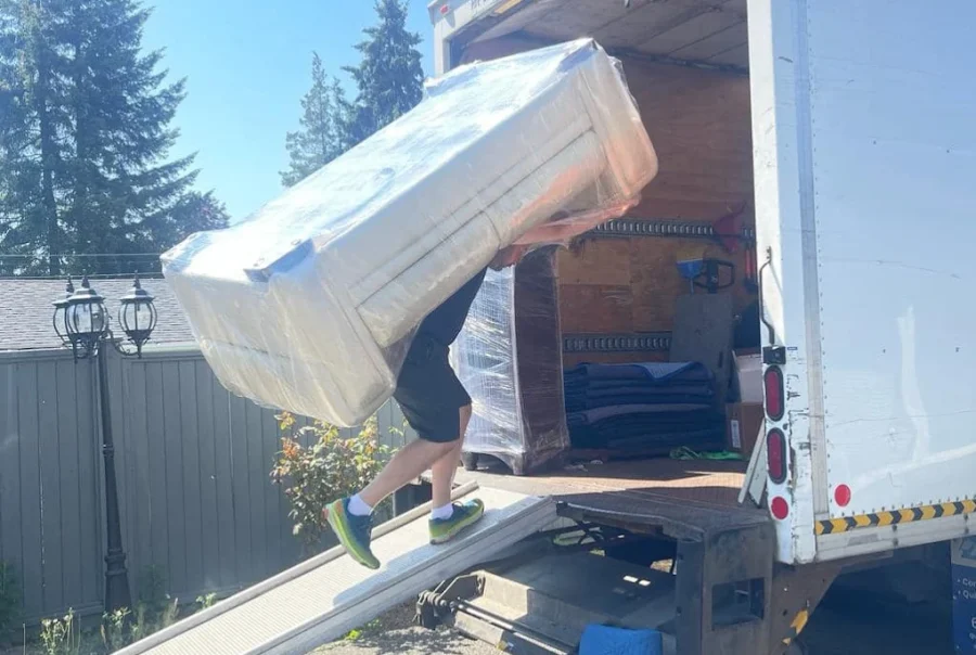 Local movers Surrey BC loading household furniture into moving truck